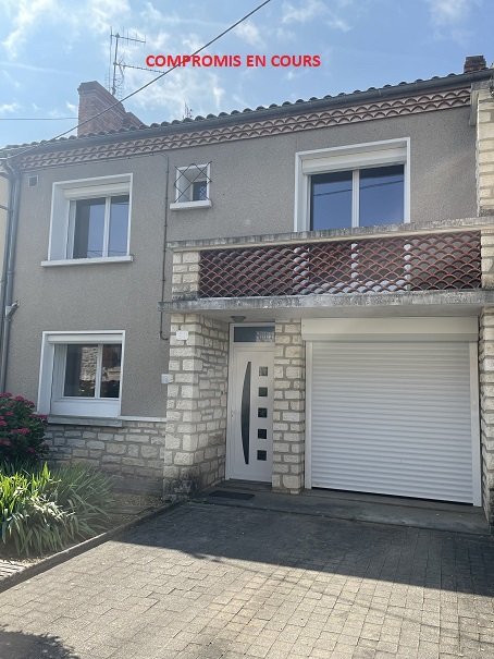 Maison de quartier avec jardin et garage.